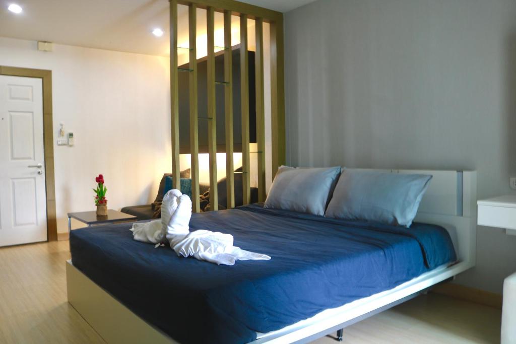 a bed with a stuffed animal on top of it at The View Condominium Suan Luang, Phuket Town in Phuket