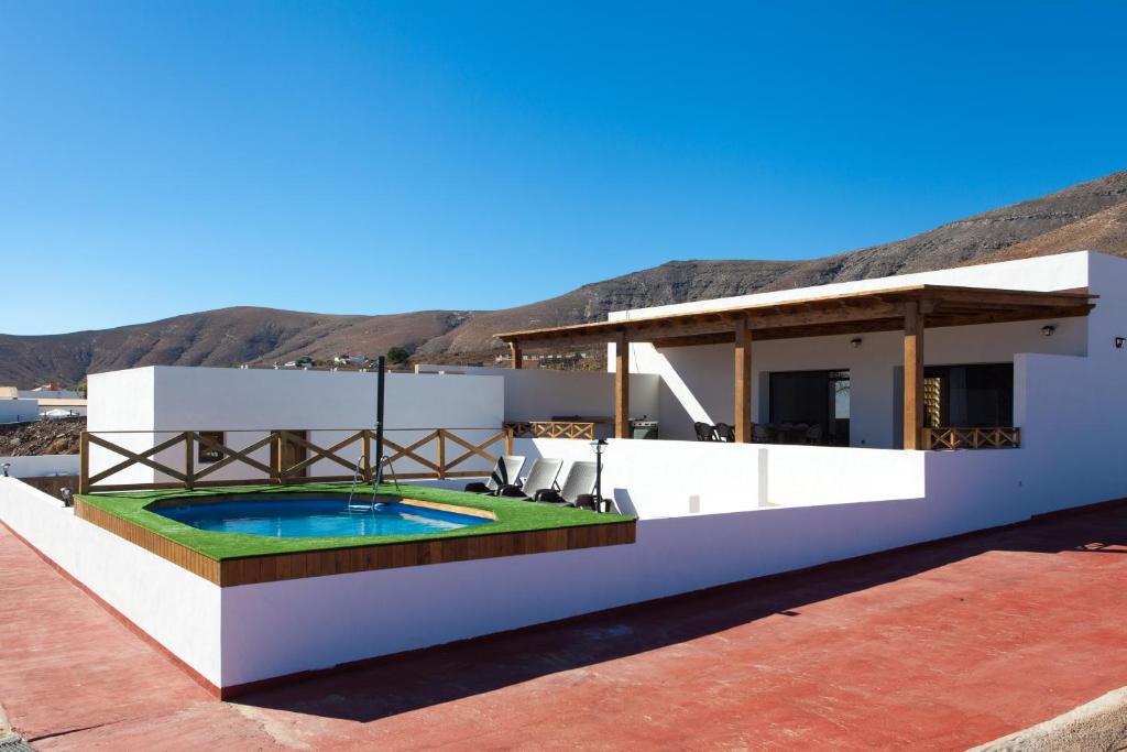 une villa avec une piscine sur le toit dans l'établissement Casa el Aceitunal, à Tetir