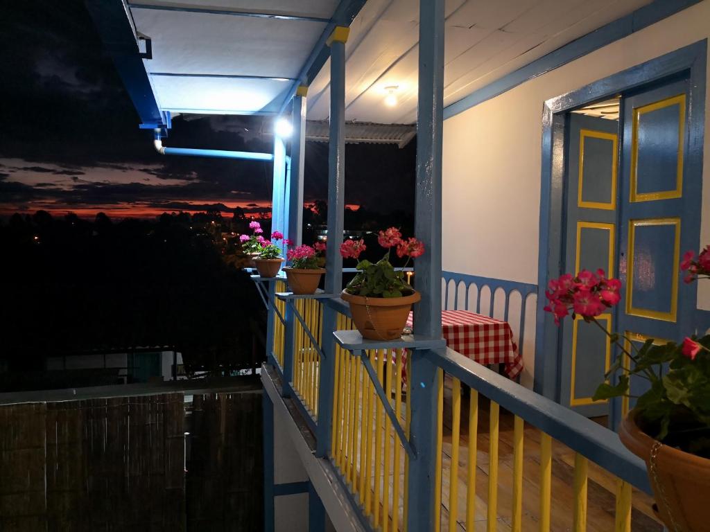 a balcony with potted plants on a house at night at Hotel Salento 1842 in Salento
