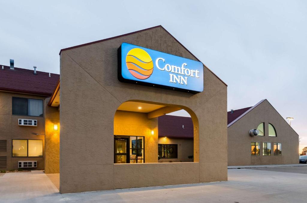 a building with a sign for a comfort inn at Comfort Inn in Colby