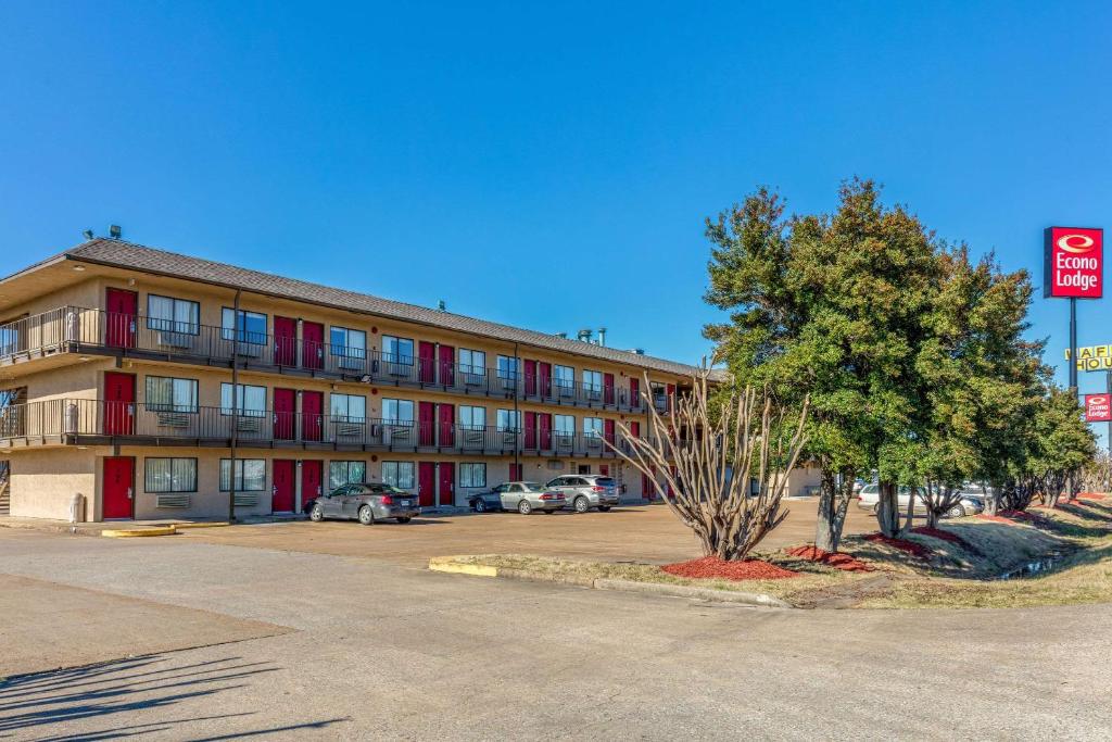 a building with a parking lot in front of it at America Best Value Inn in West Memphis