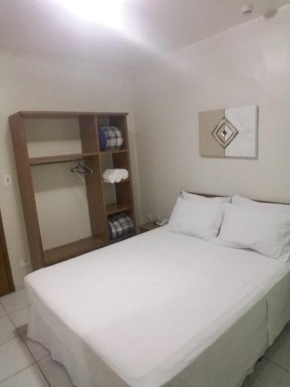 Postel nebo postele na pokoji v ubytování Ipê Guaru Hotel