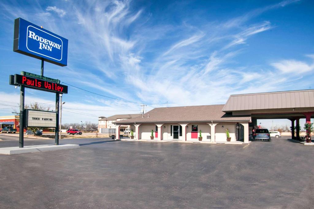 a gas station with a sign in front of it at Rodeway Inn in Pauls Valley