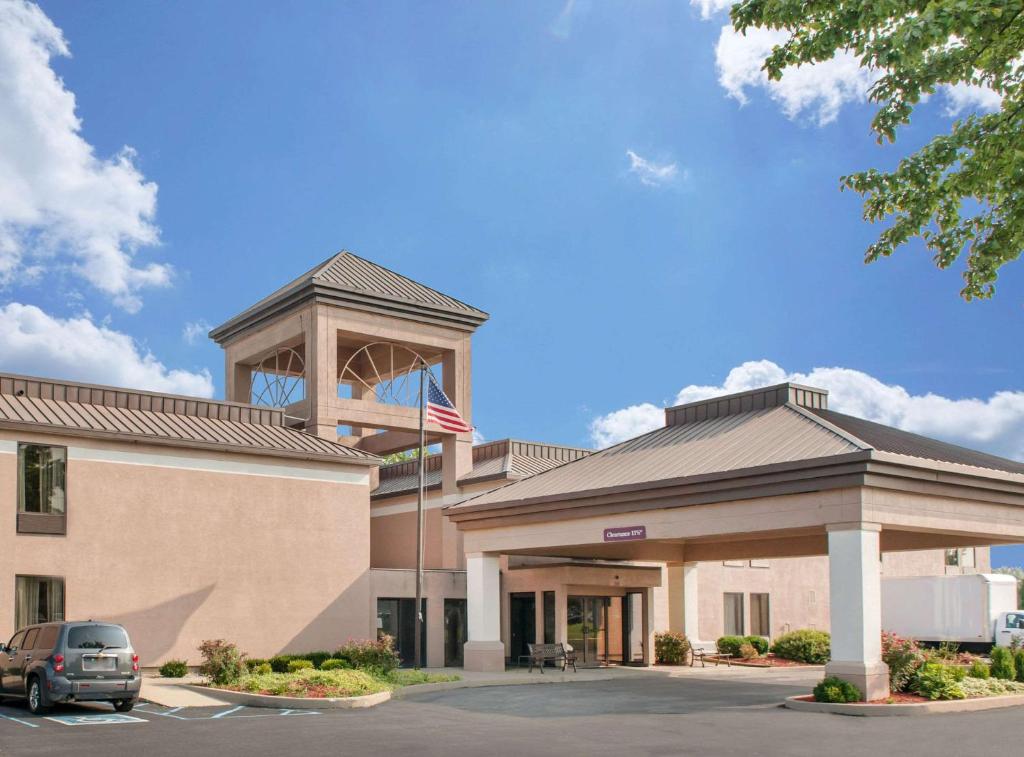 a building with an american flag in front of it at Quality Inn & Suites Near Amish Country in Rushville