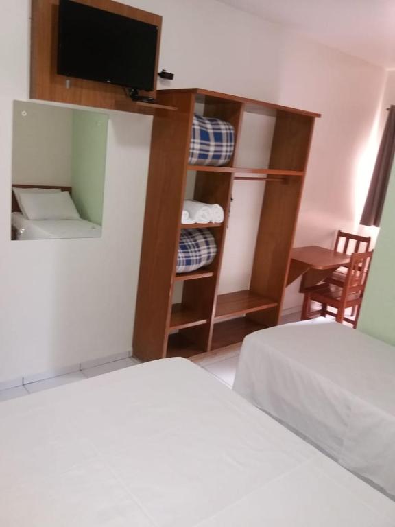 Postel nebo postele na pokoji v ubytování Ipê Guaru Hotel