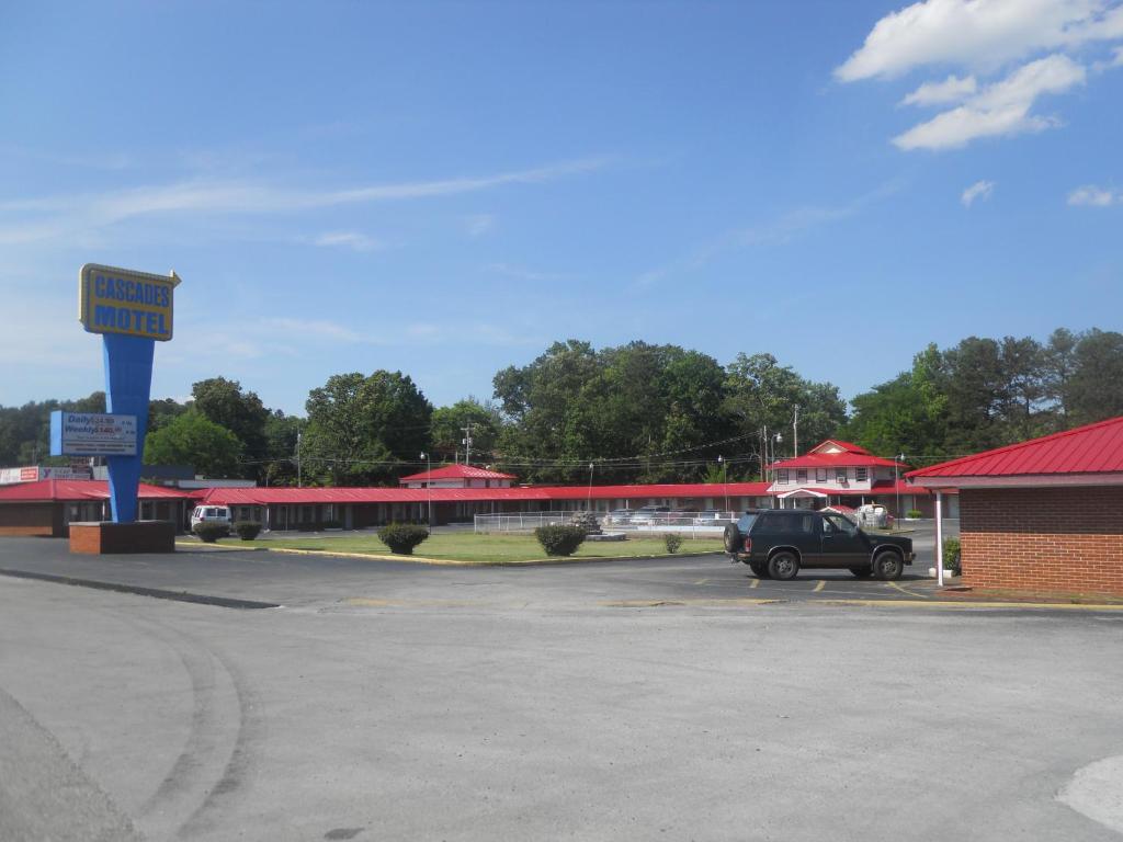 a car parked in a parking lot next to a building at Cascades Motel - Chattanooga in Chattanooga