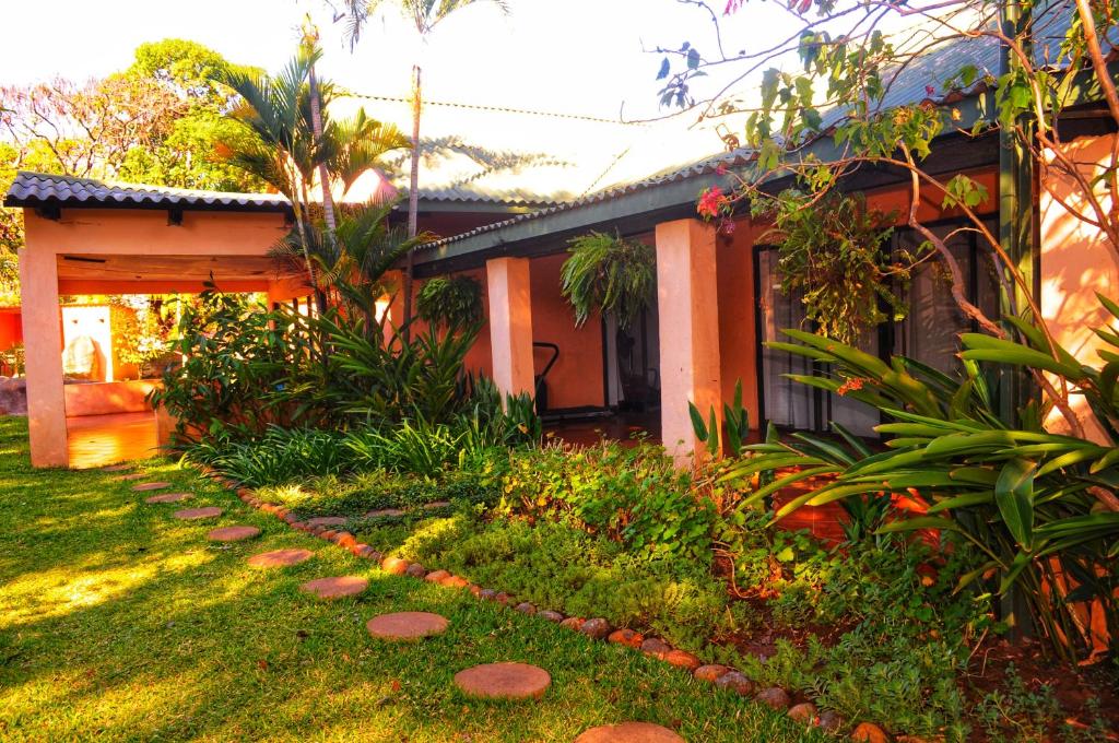 a house with a garden in front of it at Butterfly Apartments in Livingstone