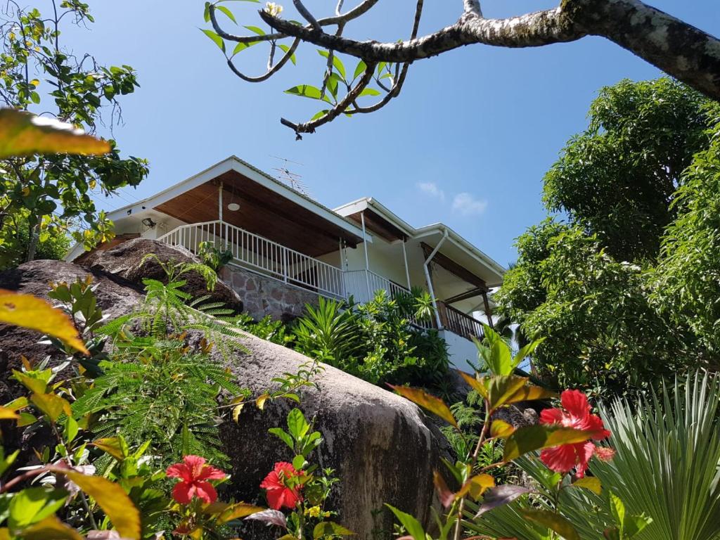 a house on top of a hill with flowers at Passage du Soleil in Anse Possession