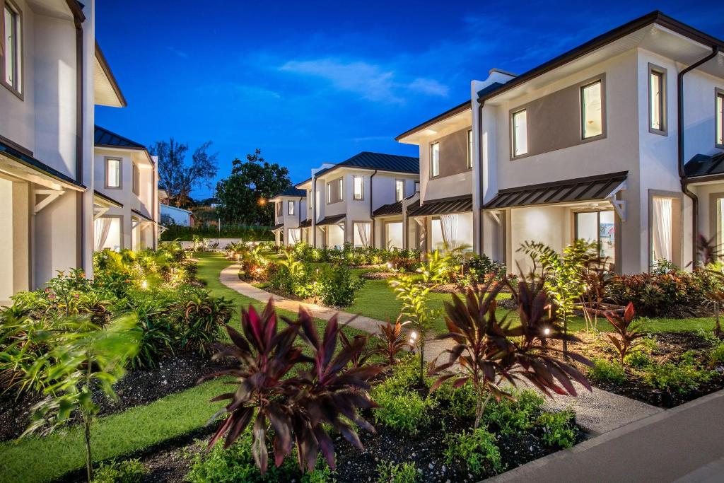 a row of houses with plants and trees at Beach View Hotel in Saint James