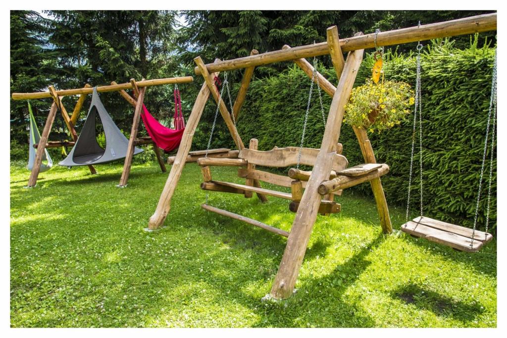 a group of swings in a yard with grass at U Bernardýna in Harrachov