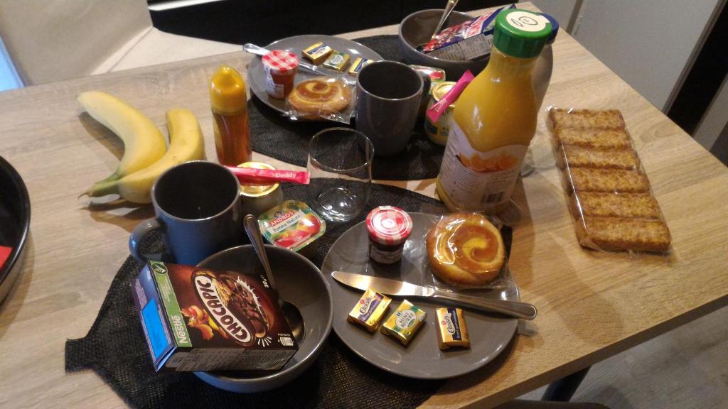 a table with a bunch of food and drinks on it at La Suite Romantique avec Jacuzzi au Cœur de Perpignan in Perpignan