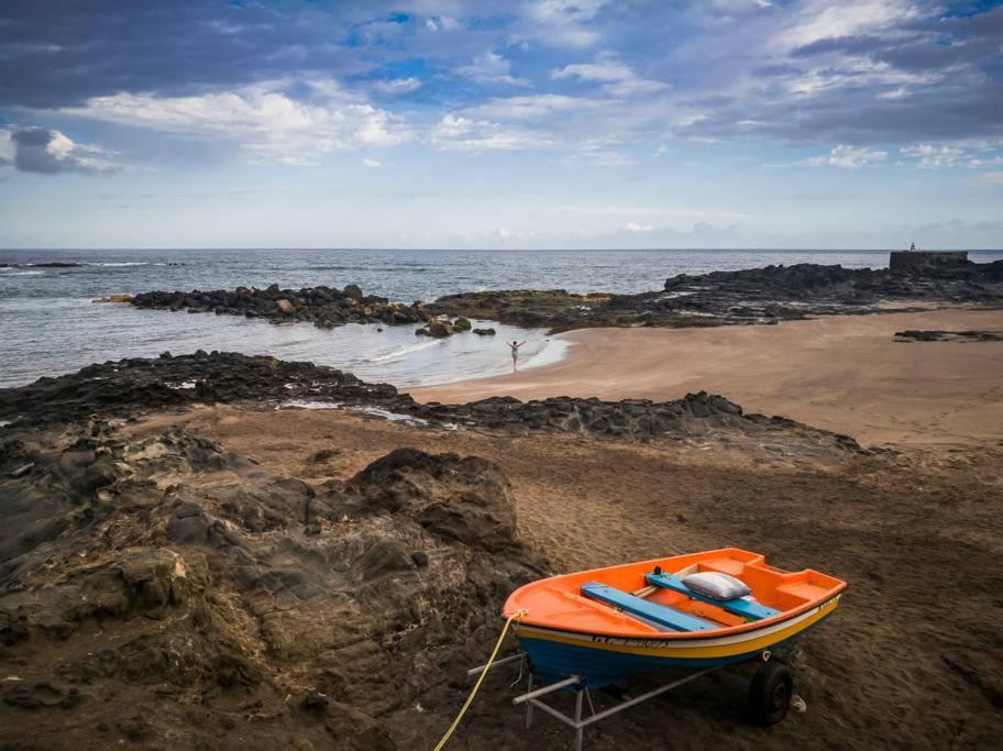 a boat sitting on the shore of a beach at Casa Aridani in Arucas