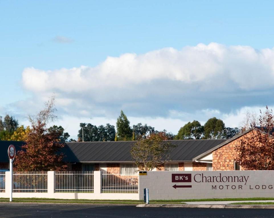 a building with a sign for the chaminary motor lodge at BK's Chardonnay Motor Lodge in Masterton