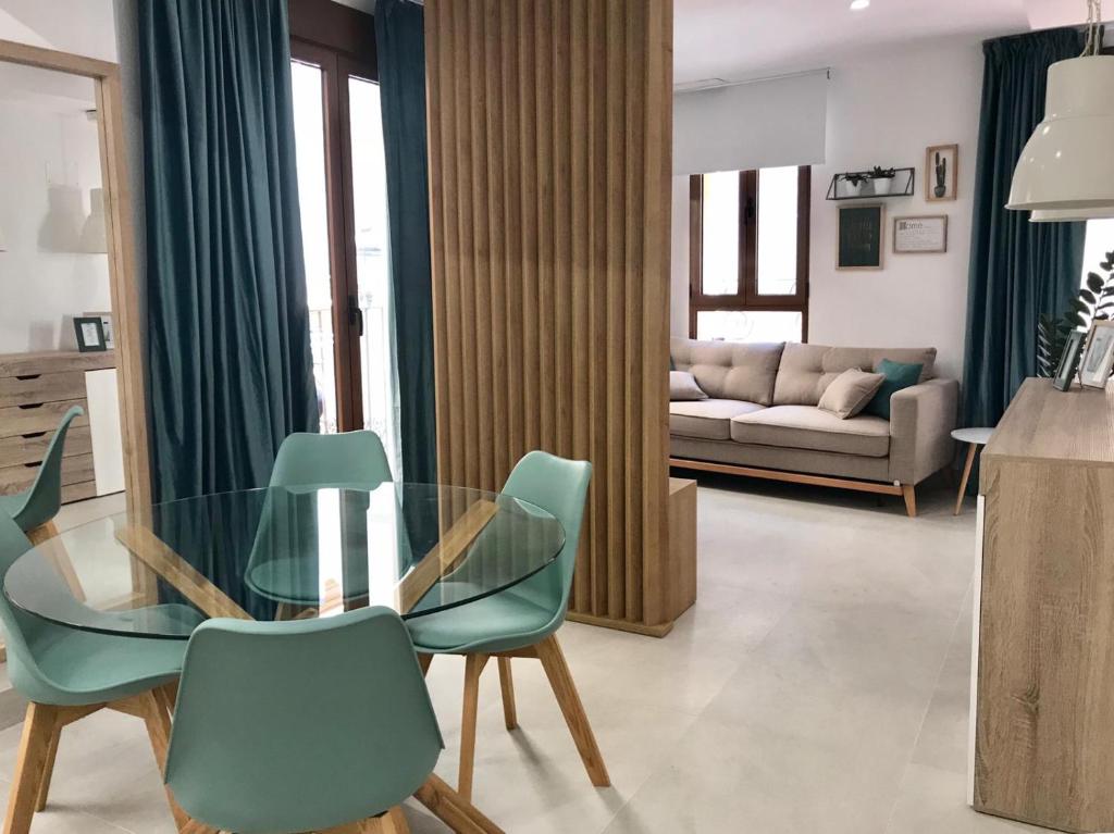 a living room with a glass table and chairs at Apartamento Joseph , luminoso, bonito y muy céntrico in Valencia