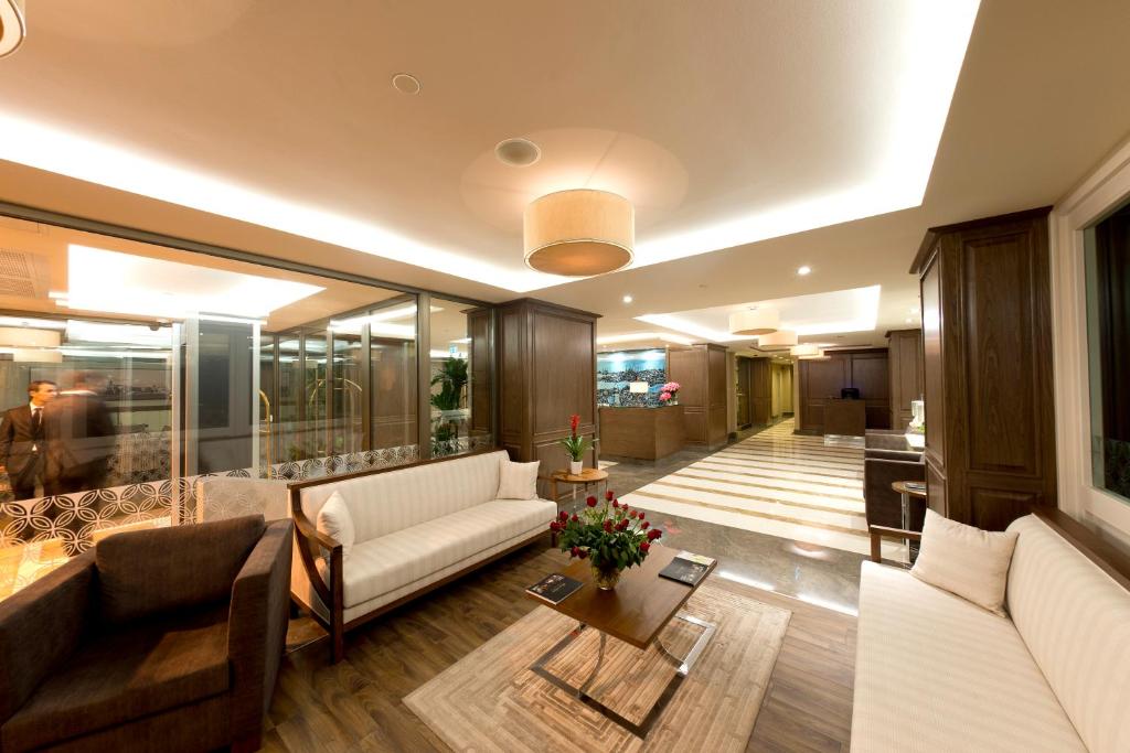 a living room with a couch and a table at Nidya Hotel Galataport in Istanbul