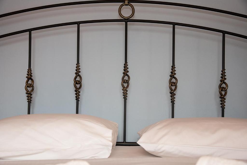 a bedroom with a bed with white sheets at Petra Traditional House in Episkopión