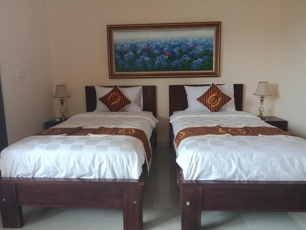 Postel nebo postele na pokoji v ubytování Ubud Taksu Homestay