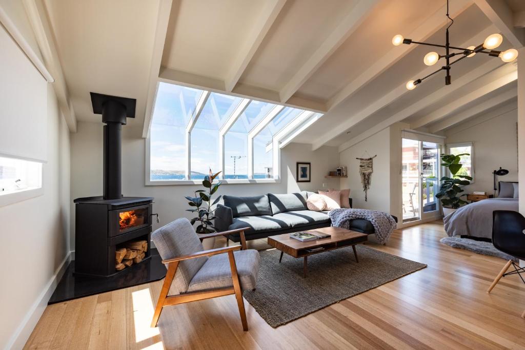 a living room with a couch and a fireplace at Litora Accommodation in Hobart