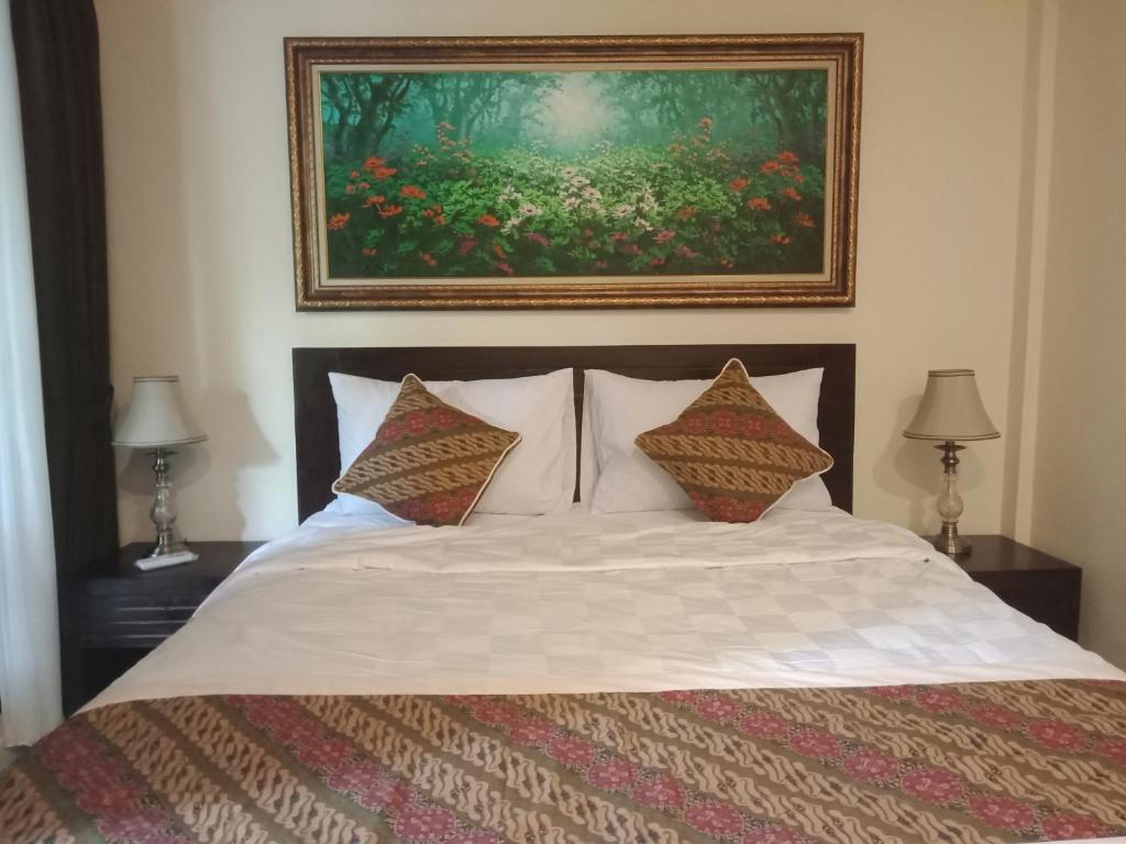 Postel nebo postele na pokoji v ubytování Ubud Taksu Homestay