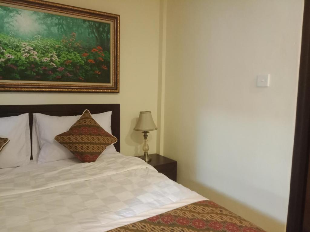 Postel nebo postele na pokoji v ubytování Ubud Taksu Homestay