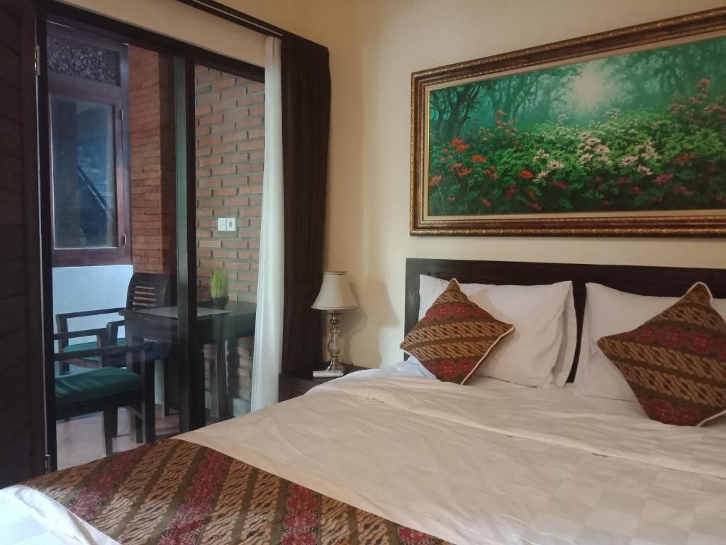 Postel nebo postele na pokoji v ubytování Ubud Taksu Homestay