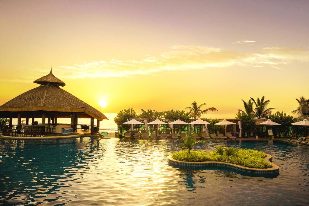 a resort with a pool with a gazebo at The Sailing Bay Beach Resort in Mui Ne