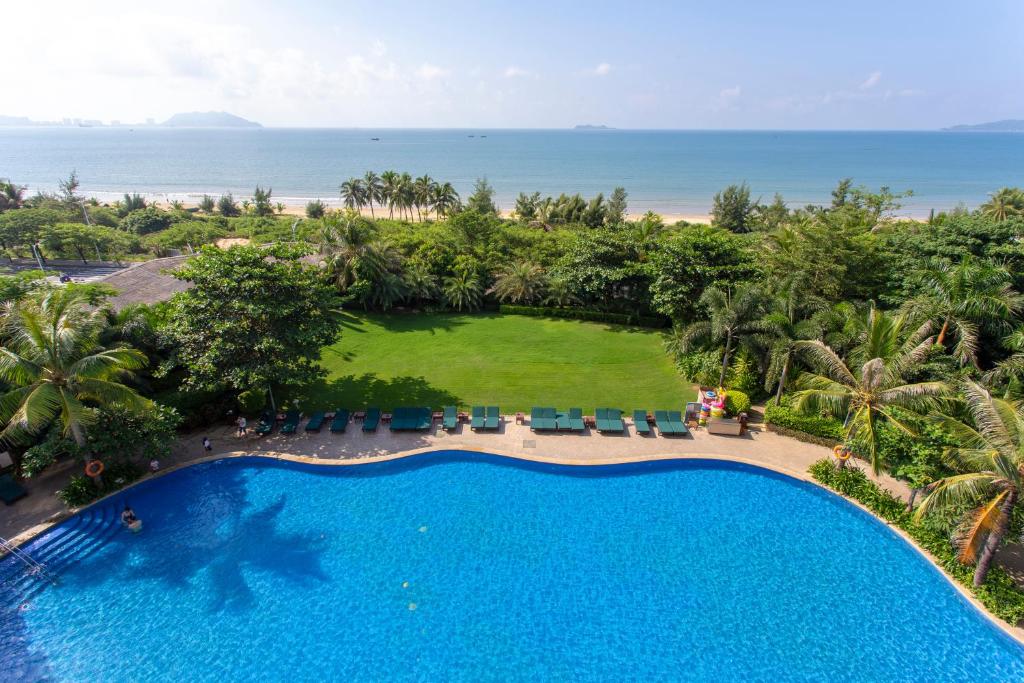 an overhead view of a swimming pool and the ocean at Sanya Seacube Holiday Hotel in Sanya