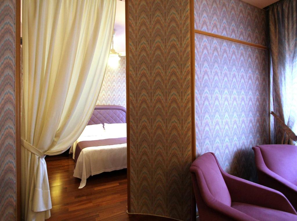 Postel nebo postele na pokoji v ubytování Hotel Cicolella