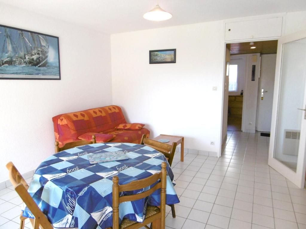 a dining room with a table and a chair at Appartment Erwan in Arzon