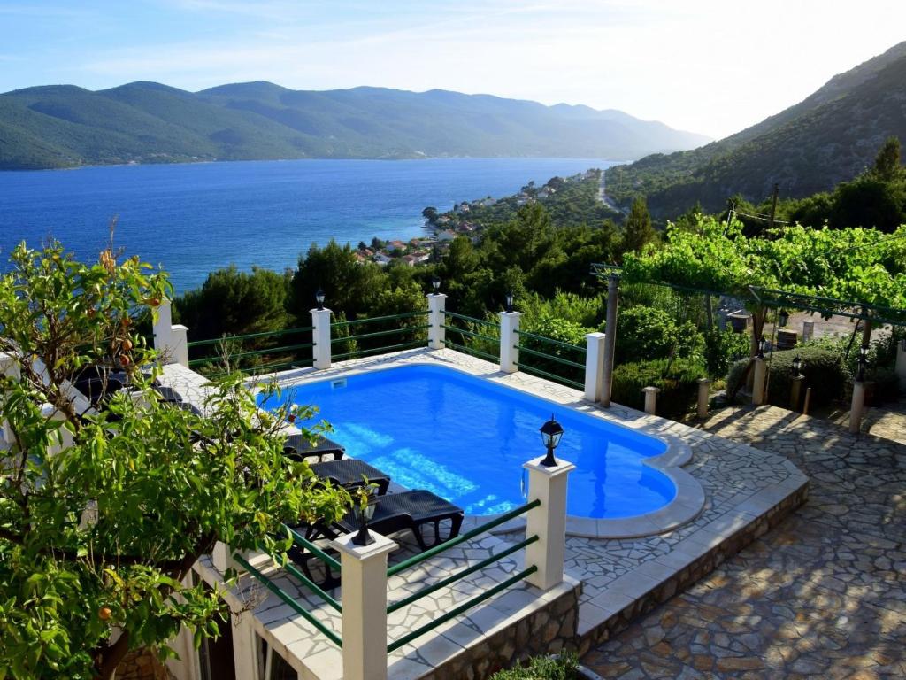 a swimming pool with a view of the water at Villa Anita by Interhome in Viganj