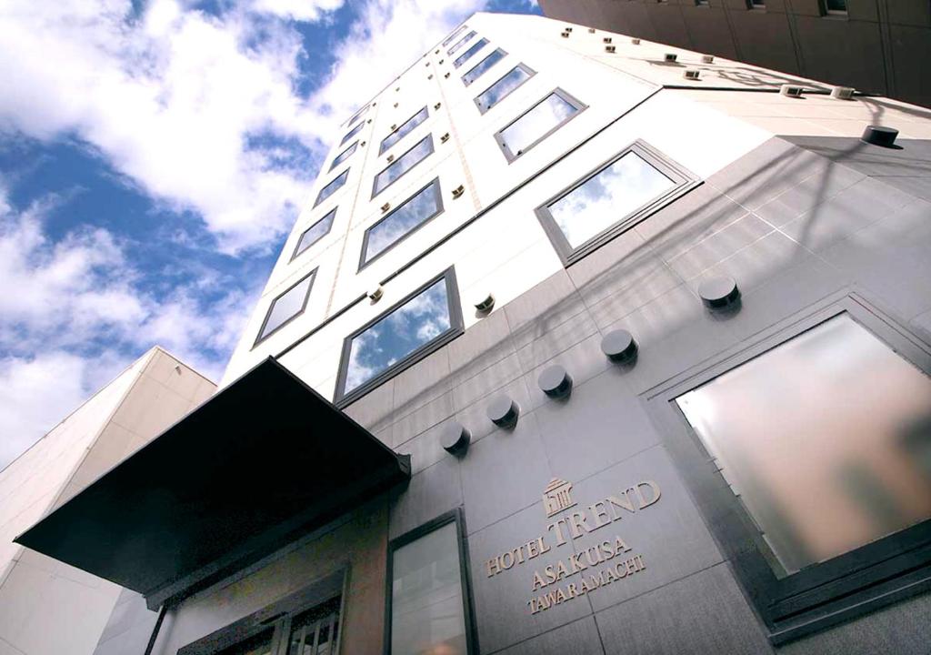 a tall white building with windows on top of it at Hotel Trend Asakusa Tawaramachi in Tokyo