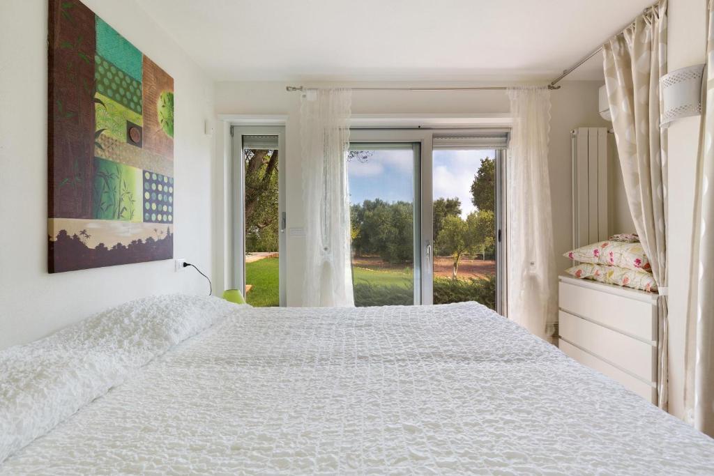 Łóżko lub łóżka w pokoju w obiekcie Villa Carlita by Perle di Puglia