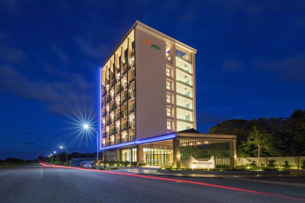 a large building with a lit up facade at night at Naruwan Galaxy Place in Taitung City