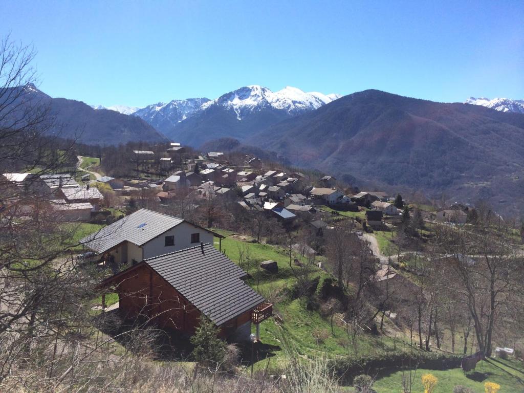 un pequeño pueblo en una colina con montañas en el fondo en Les Granges d'Ignaux, en Ignaux