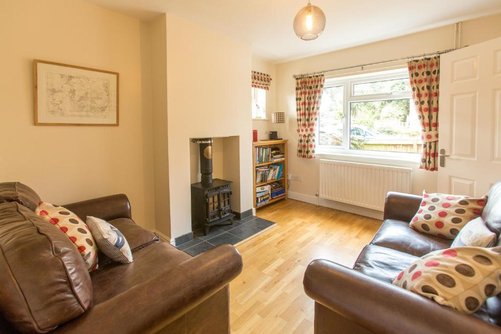 a living room with a couch and a fireplace at 18 Pilgrim’s Way in Thorpeness