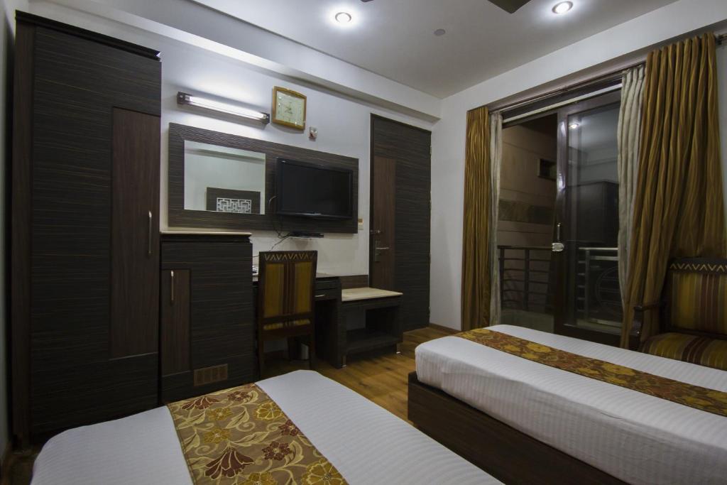 Postel nebo postele na pokoji v ubytování Hotel Sunstar Heights