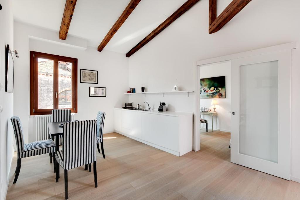 Biały salon ze stołem i krzesłami w obiekcie San Marcuola apartment w Wenecji