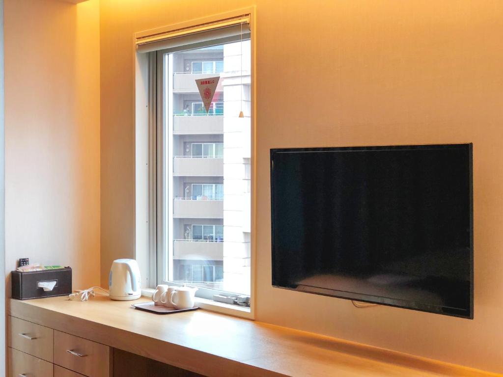 TV a/nebo společenská místnost v ubytování Hotel Comfact