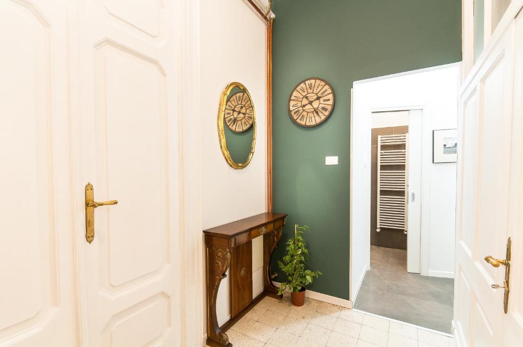 a hallway with a door and a clock on the wall at Agli incanti in Trieste