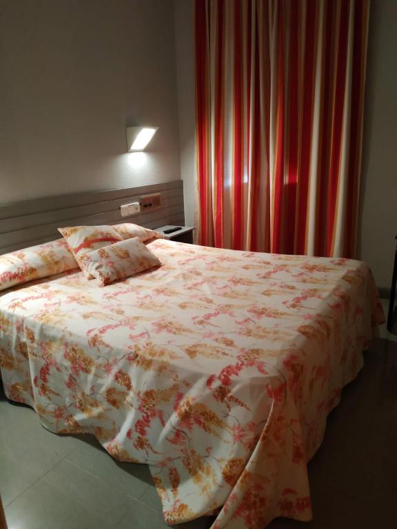 Postel nebo postele na pokoji v ubytování Hotel Fidalgo