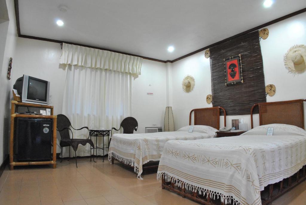 Postel nebo postele na pokoji v ubytování Surfside Boracay Resort