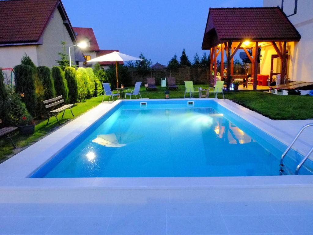 a swimming pool in a backyard at night at Riviera -Adults Only in Rewal