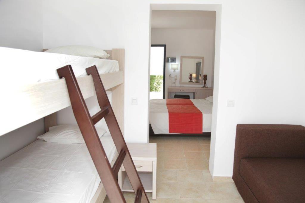 a room with two bunk beds and a bedroom at Rodos Star Hotel in Afantou
