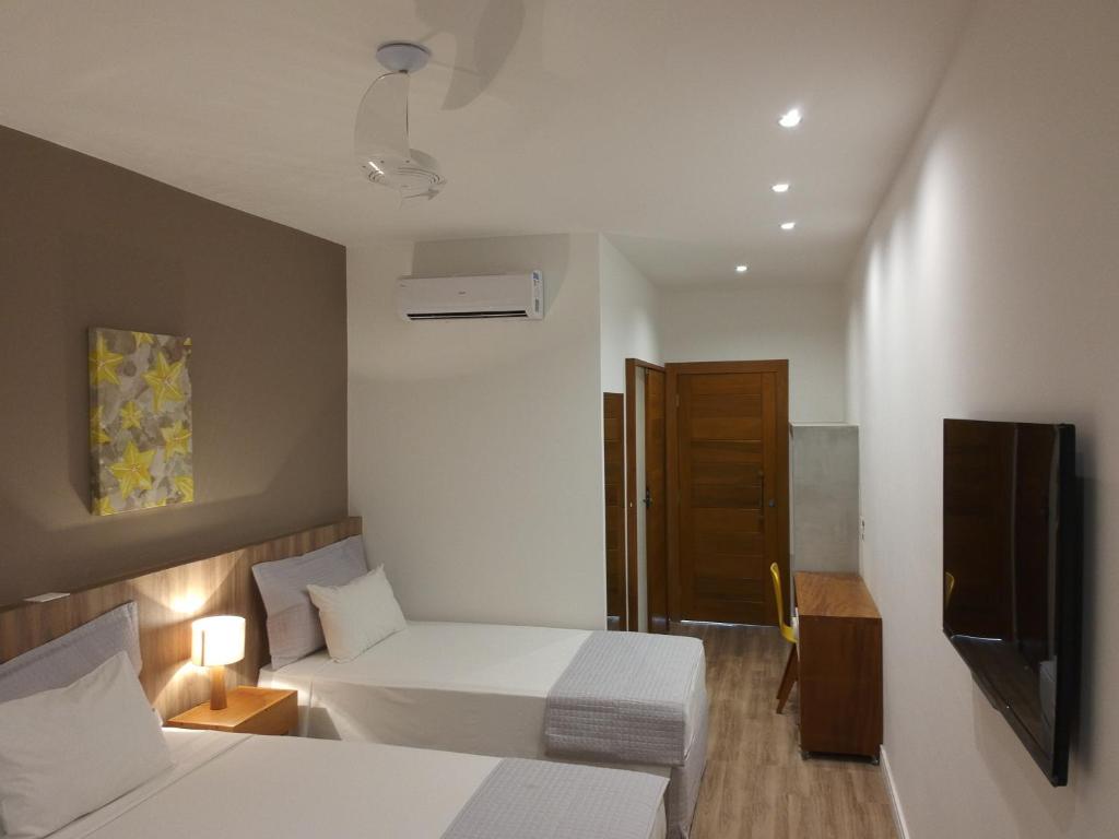Postel nebo postele na pokoji v ubytování Carambola Hotel