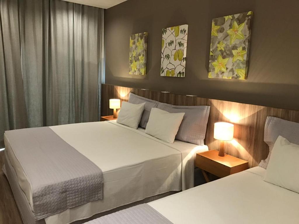 Postel nebo postele na pokoji v ubytování Carambola Hotel
