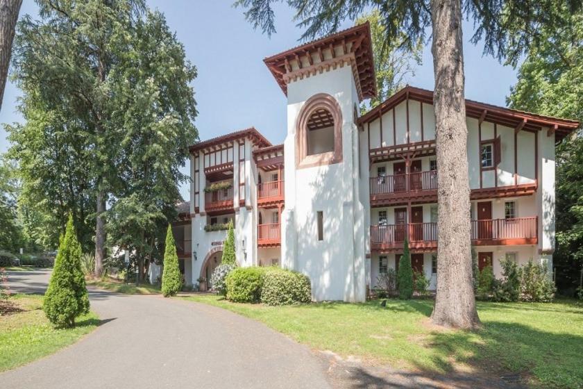 a large building with trees in front of it at Parc Arradoy in Saint-Jean-Pied-de-Port