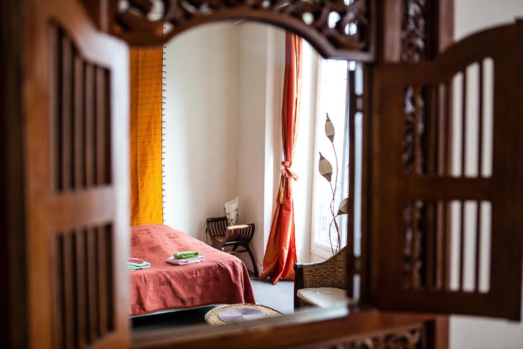 a bedroom with a red bed and a window at Nice Riviera Sweet Home in Nice