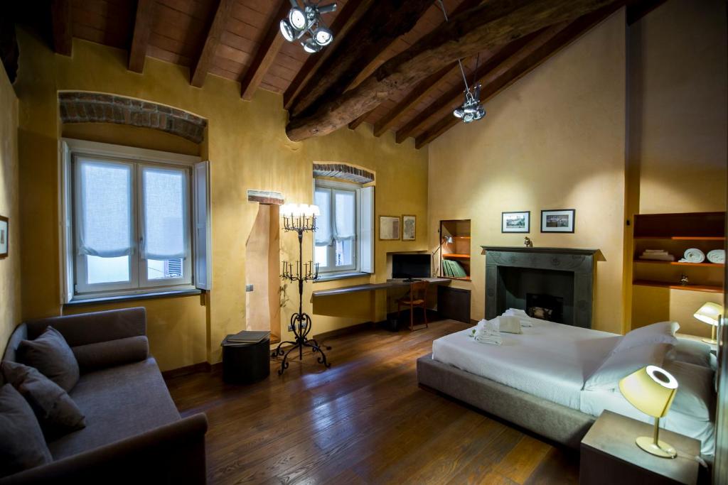 a living room with a bed and a couch at Locanda Mimmo in Bergamo