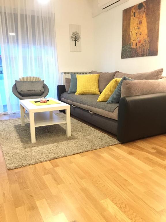 a living room with a couch and a coffee table at Apartment Šola in Zagreb
