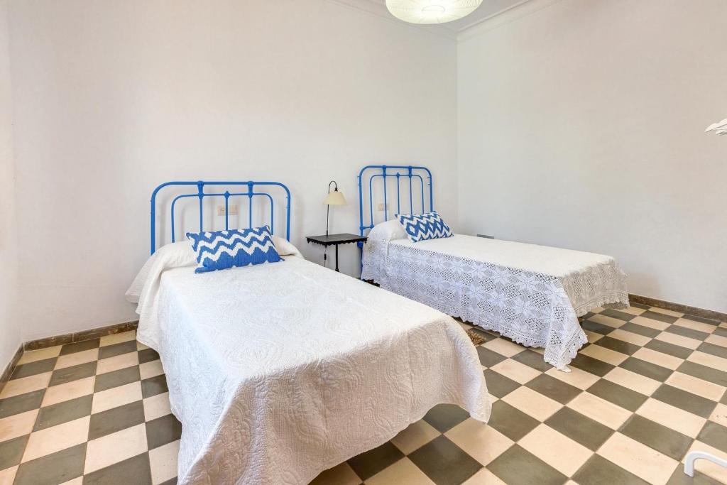 A bed or beds in a room at Villa Palma, Establiments